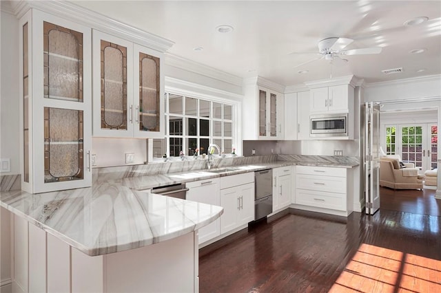 540 Blackstone Blvd, Providence, RI 02906 - kitchen with a sink, a peninsula, dark wood-style flooring, ceiling fan, and appliances with stainless steel finishes