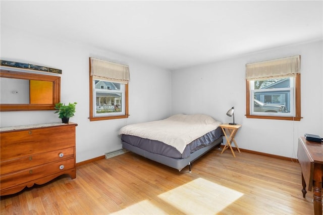 bedroom with baseboards and light wood-style flooring