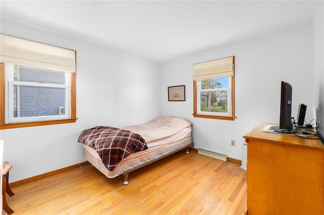 bedroom featuring visible vents, light wood-style flooring, and baseboards