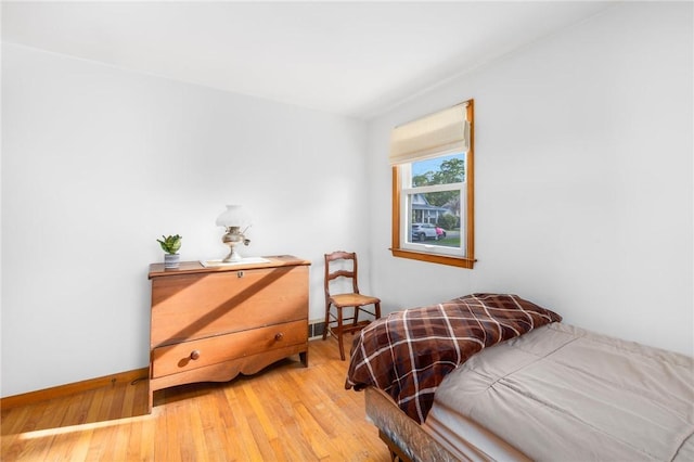 bedroom featuring light wood-style floors and baseboards
