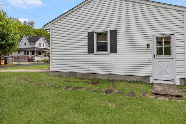 view of property exterior with a lawn