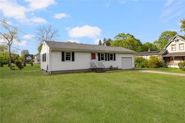 view of front of home featuring a front yard, aphalt driveway, and a garage