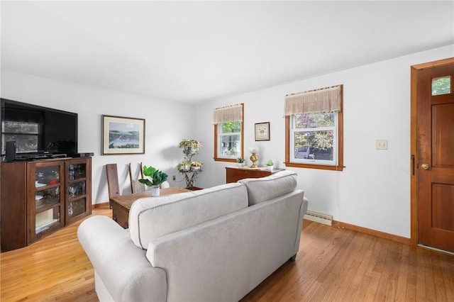 living room with baseboards, light wood-style flooring, and baseboard heating