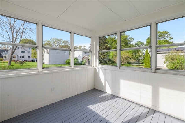 unfurnished sunroom featuring a residential view and plenty of natural light