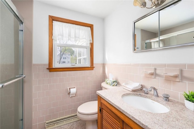 full bathroom featuring toilet, a wainscoted wall, tile walls, a shower stall, and vanity
