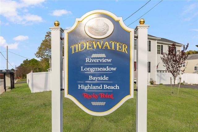 community sign with a yard and fence