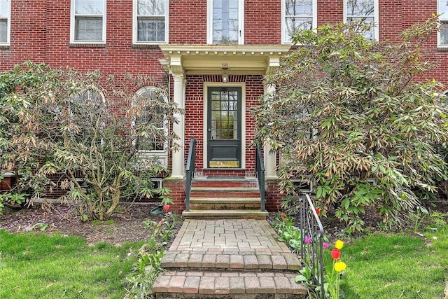 property entrance with brick siding