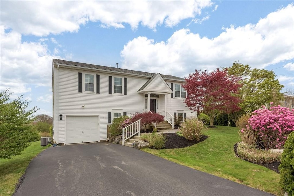 39 President Dr, Narragansett, RI 02882 - raised ranch with central AC unit, a garage, a front yard, and driveway