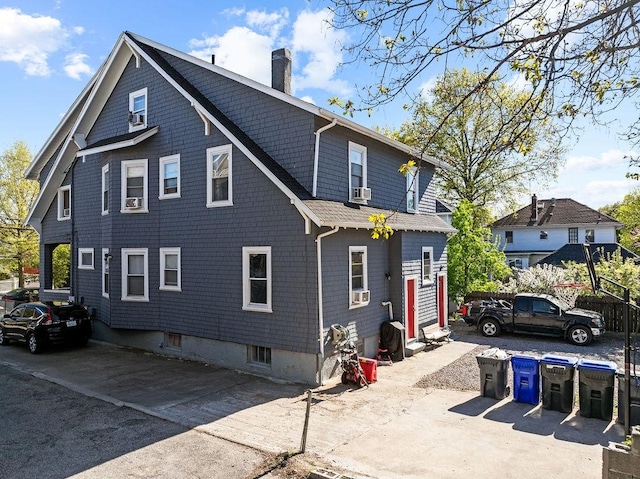 view of side of home featuring a chimney