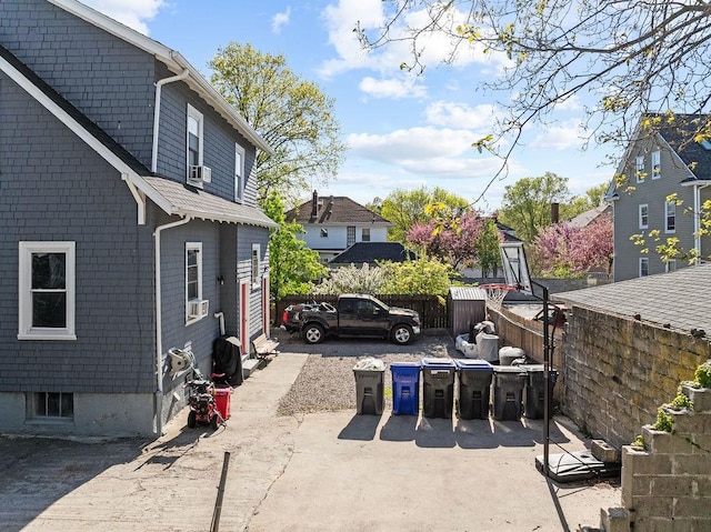 view of patio with cooling unit and fence