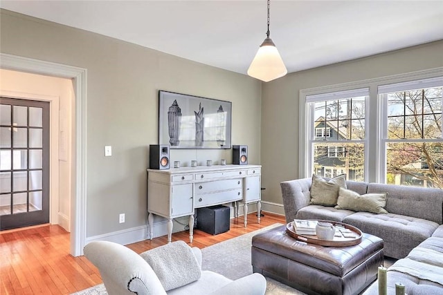 living room featuring light wood-type flooring and baseboards
