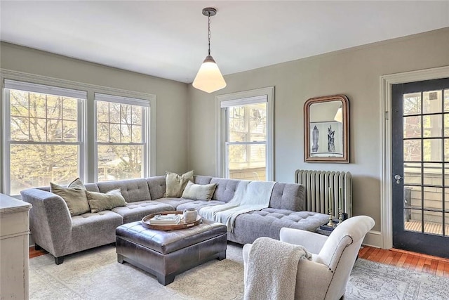 living room with light wood-style floors and radiator heating unit