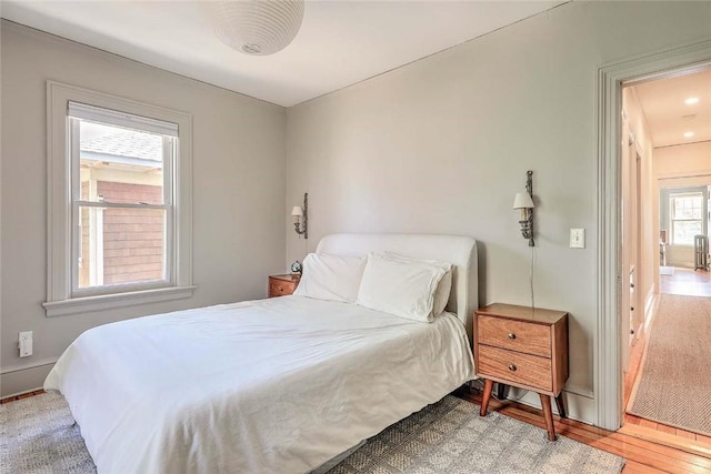 bedroom featuring baseboards and wood finished floors