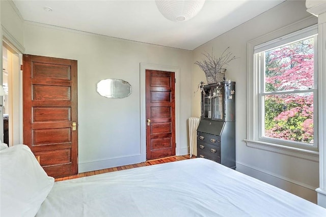 bedroom featuring wood finished floors and baseboards