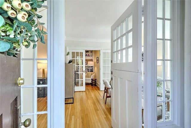 doorway to outside featuring crown molding, french doors, and hardwood / wood-style floors