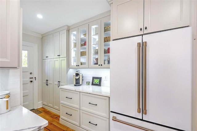 interior space featuring high end fridge and light wood-style flooring
