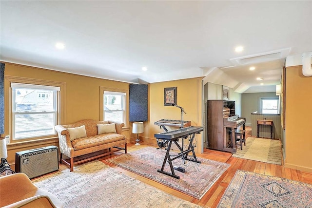living room featuring baseboards, light wood-style floors, and recessed lighting