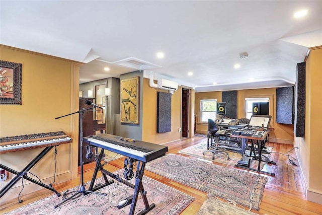 interior space featuring light wood finished floors, baseboards, a wall mounted AC, and recessed lighting