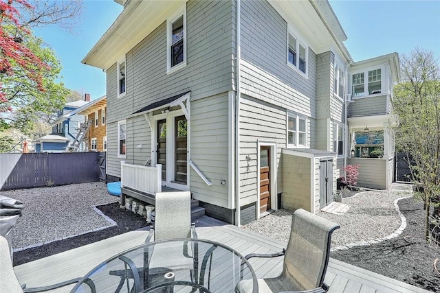 rear view of property featuring fence, outdoor dining area, and a patio area