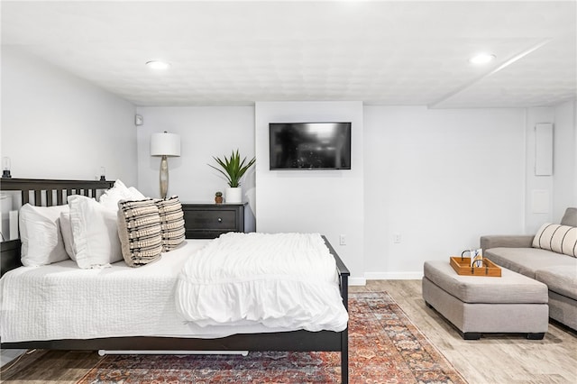 bedroom featuring baseboards, recessed lighting, and light wood-type flooring