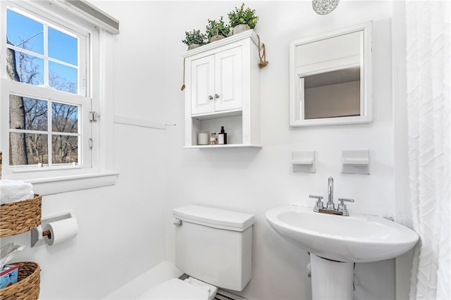 bathroom with toilet and a sink