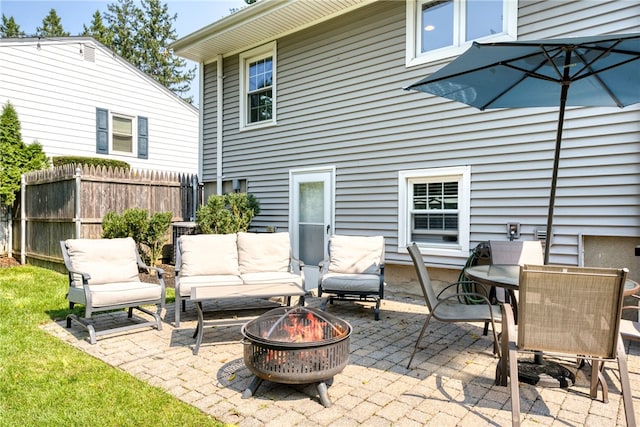 view of patio featuring a fire pit and fence