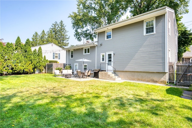 back of house with a yard, entry steps, and fence