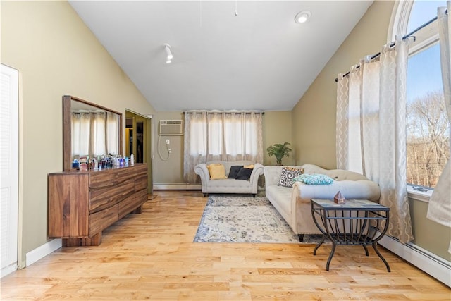 215 Rocky Point Ave, Warwick, RI 02889 - living area featuring baseboard heating, a wealth of natural light, wood finished floors, and lofted ceiling