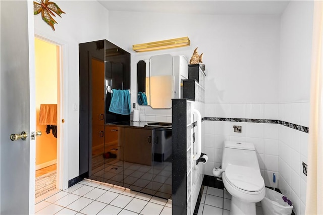 215 Rocky Point Ave, Warwick, RI 02889 - bathroom with toilet, tile patterned floors, wainscoting, and vanity