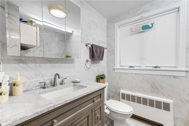 215 Rocky Point Ave, Warwick, RI 02889 - bathroom with vanity, tile walls, toilet, and radiator heating unit
