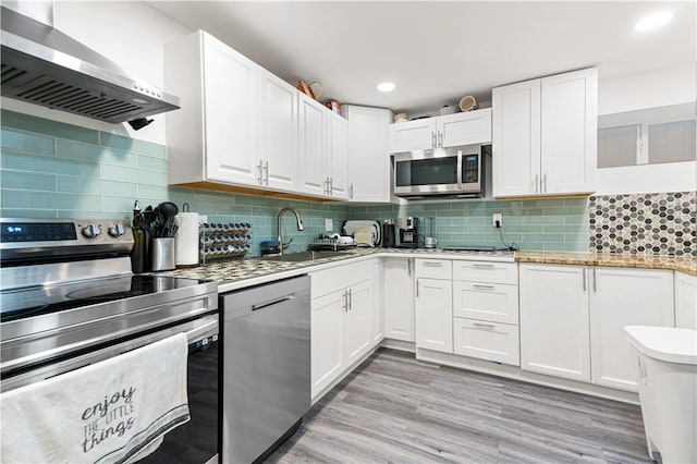 193 Harrison St, Pawtucket, RI 02860 - kitchen featuring a sink, white cabinetry, wall chimney range hood, appliances with stainless steel finishes, and recessed lighting