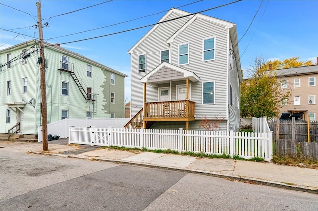193 Harrison St, Pawtucket, RI 02860 - traditional-style home with a porch, a fenced front yard, and a gate