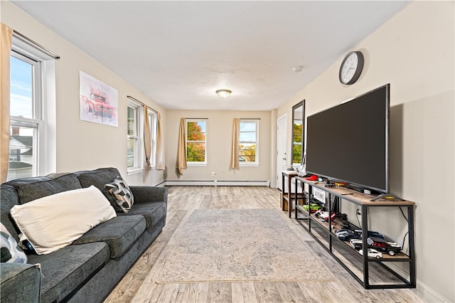 193 Harrison St, Pawtucket, RI 02860 - living area featuring light wood finished floors, baseboards, and a baseboard heating unit