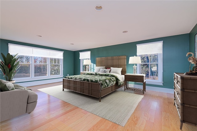 bedroom with light wood-style flooring and baseboards
