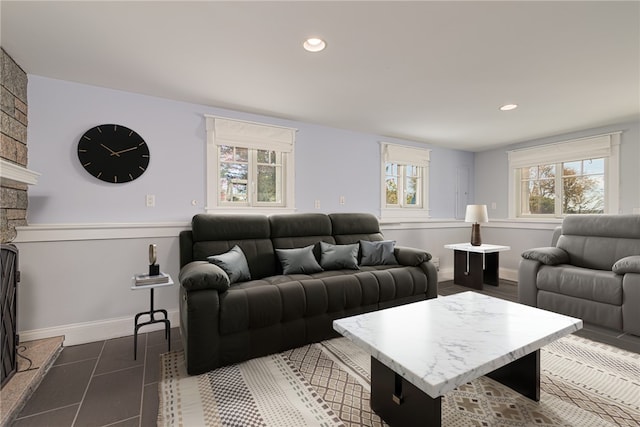 living area with a wealth of natural light, tile patterned flooring, and recessed lighting