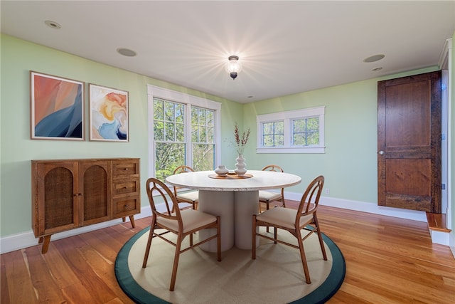 dining area with light wood finished floors and baseboards
