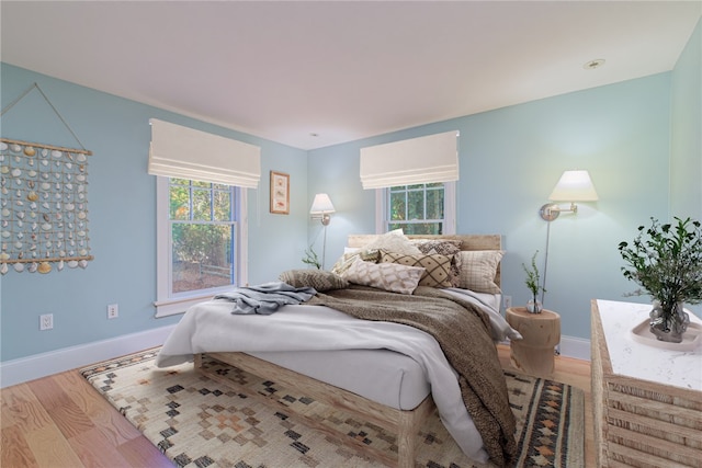 bedroom featuring baseboards and wood finished floors