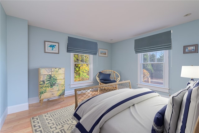 bedroom featuring light wood-type flooring and baseboards