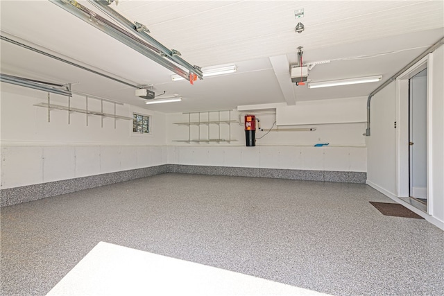 garage with baseboards and a garage door opener