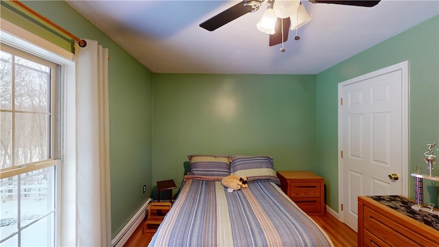 4 Tray Hollow Rd, Foster, RI 02825 - bedroom with light wood-type flooring, baseboards, a baseboard heating unit, and a ceiling fan