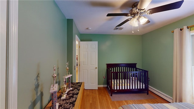 4 Tray Hollow Rd, Foster, RI 02825 - bedroom with a baseboard heating unit, light wood finished floors, a nursery area, and a ceiling fan