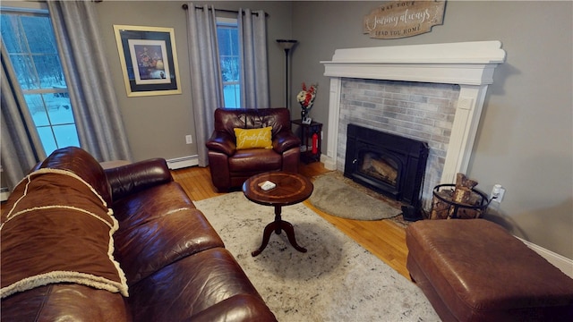 4 Tray Hollow Rd, Foster, RI 02825 - living room with a brick fireplace, wood finished floors, baseboard heating, and baseboards