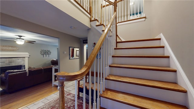 4 Tray Hollow Rd, Foster, RI 02825 - stairway featuring ceiling fan, a fireplace, a towering ceiling, and wood finished floors