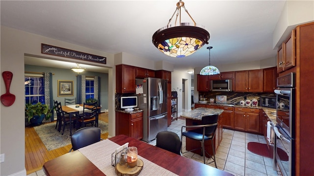 4 Tray Hollow Rd, Foster, RI 02825 - kitchen with appliances with stainless steel finishes, decorative backsplash, a kitchen island, hanging light fixtures, and light tile patterned floors