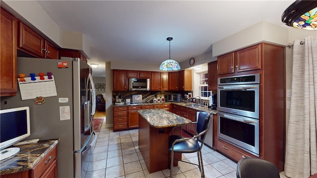 4 Tray Hollow Rd, Foster, RI 02825 - kitchen featuring appliances with stainless steel finishes, a sink, a center island, decorative backsplash, and light tile patterned floors