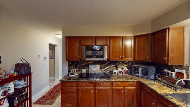 4 Tray Hollow Rd, Foster, RI 02825 - kitchen with stainless steel microwave, black electric stovetop, tasteful backsplash, light tile patterned flooring, and stone counters