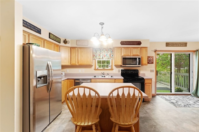 51 Mill Rd, Foster, RI 02825 - kitchen with appliances with stainless steel finishes, light brown cabinetry, a sink, a chandelier, and light countertops