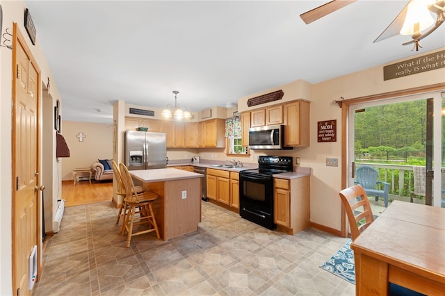 51 Mill Rd, Foster, RI 02825 - kitchen with appliances with stainless steel finishes, light countertops, a sink, a center island, and a kitchen breakfast bar
