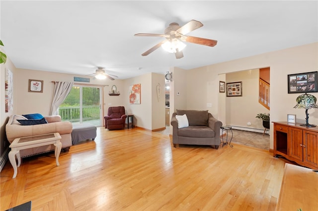 51 Mill Rd, Foster, RI 02825 - living room featuring baseboard heating, a ceiling fan, light wood-style floors, and stairway