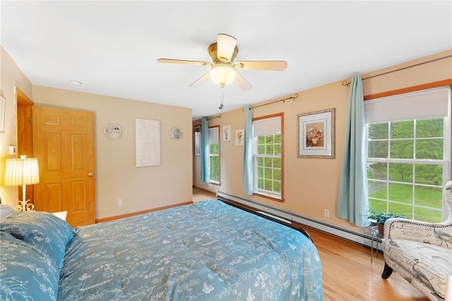 51 Mill Rd, Foster, RI 02825 - bedroom with baseboard heating, wood finished floors, and ceiling fan